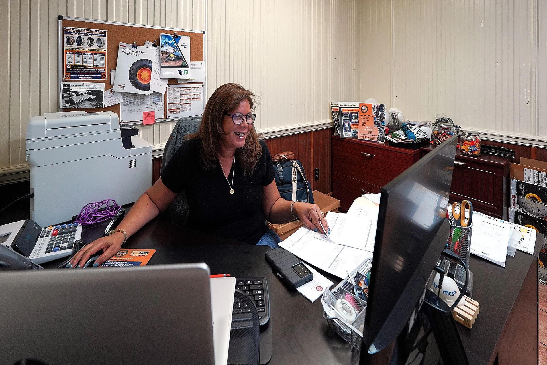 Heavy Duty Tires team member assisting customers from the office