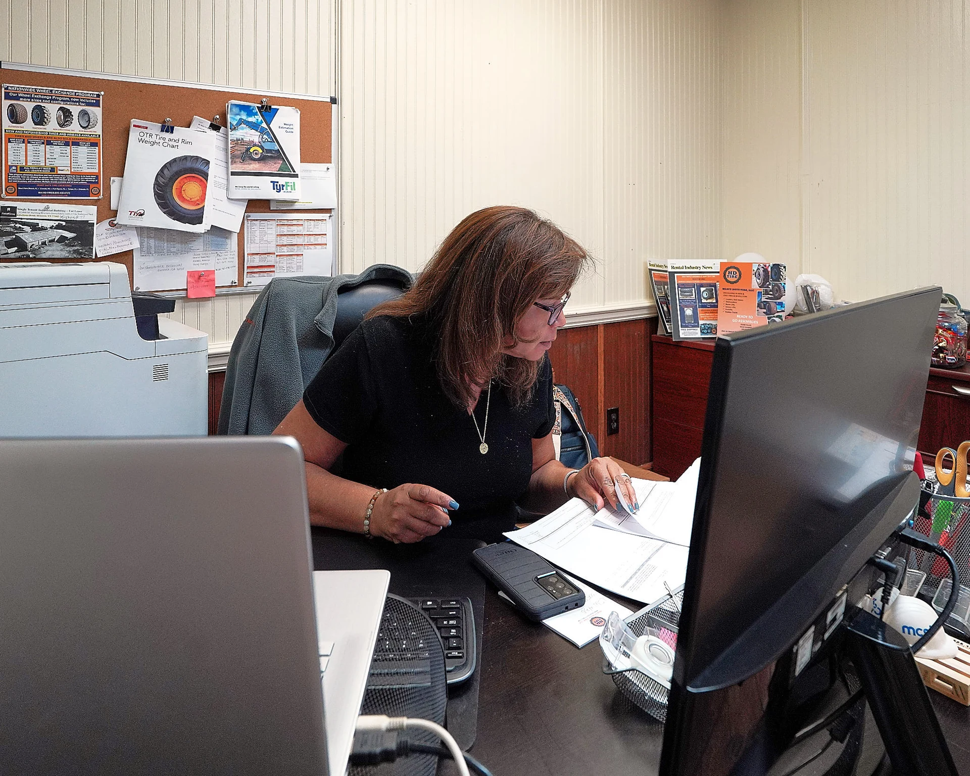 Heavy Duty Tires office team member reviewing documents