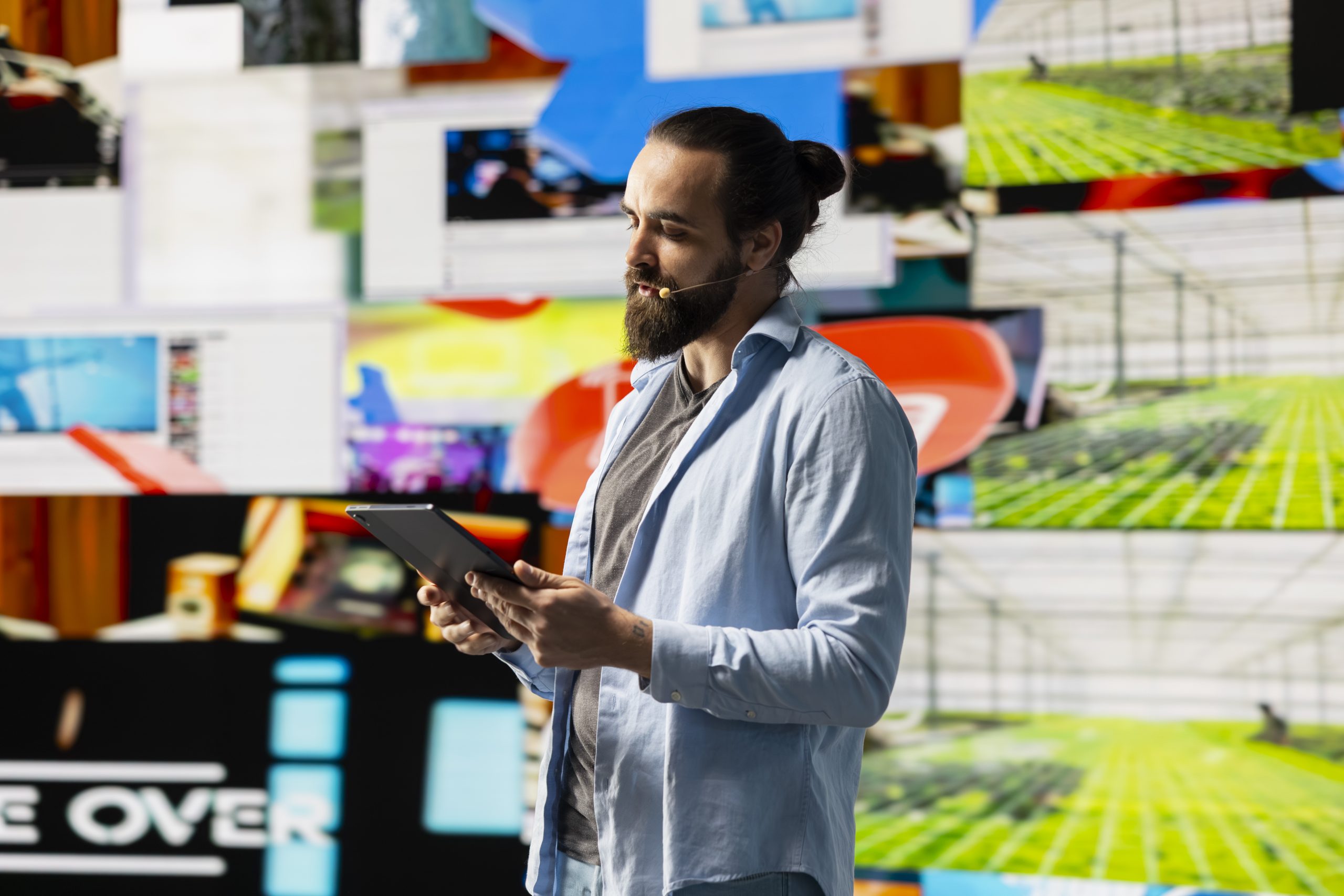 Male cool influencer hosting a live presentation with hands free microphone, engaging an audience to discuss social media reach, digital interaction and creative branding in real time. Trend setter.